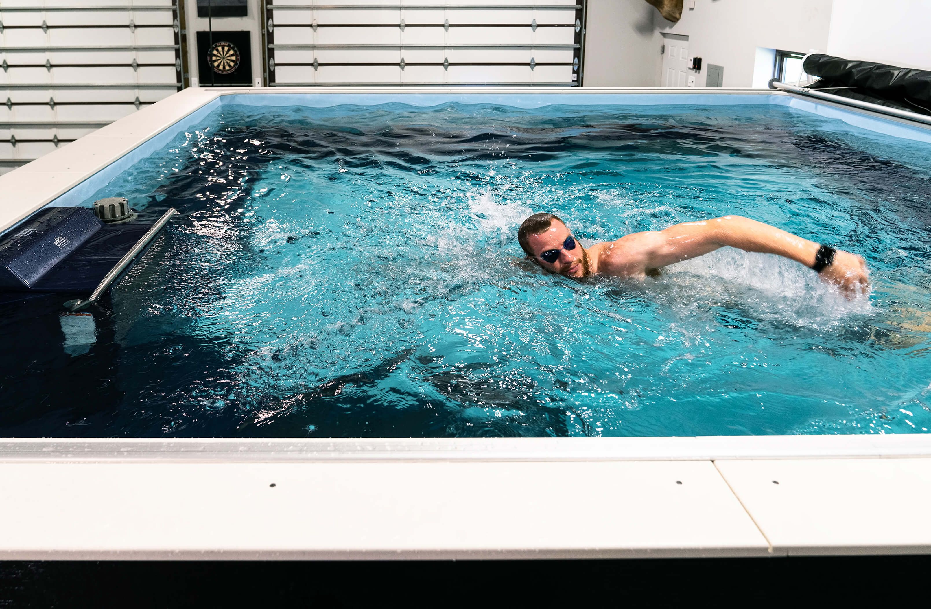 picture of NFL quarterback Carson Wentz swimming in his Endless Pools garage pool