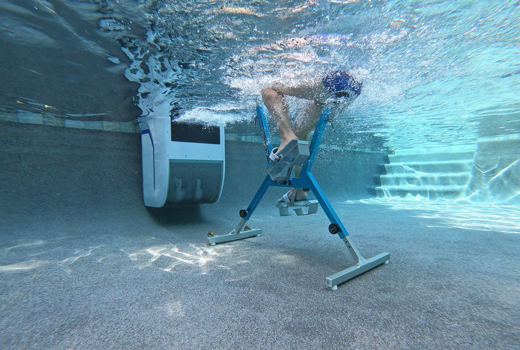 A picture of an underwater view of someone aqua cycling against the endless current.