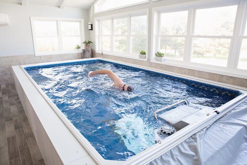 picture of a swimmer uses the Endless Pools current in his sunroom pool