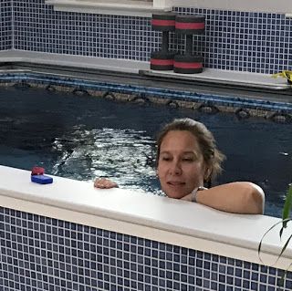 Kat in the Endless Pools swimming machine in her renovated garage