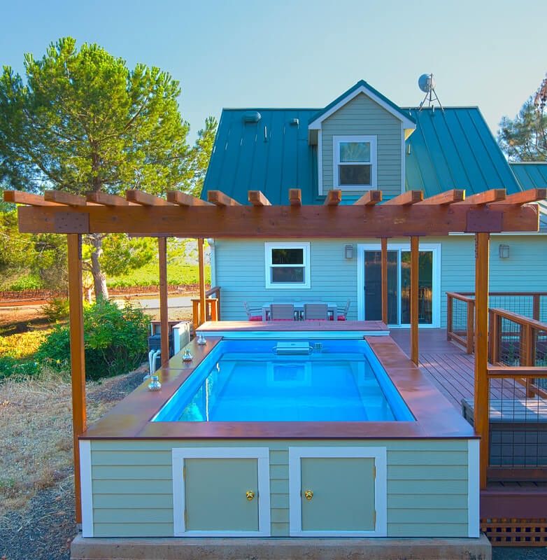 picture of an Endless Pools Custom Series pool installed aboveground with decking and a pergola