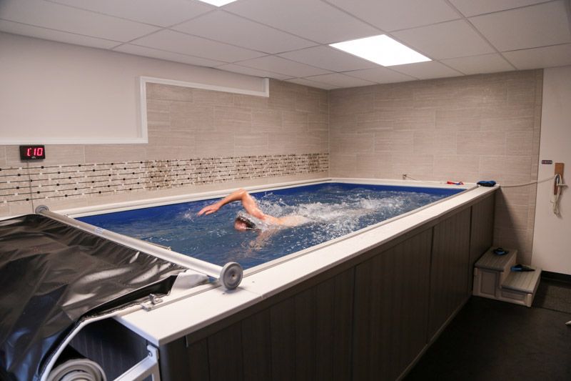 picture of Bert swimming in the Endless Pools swimming machine in his finished basement