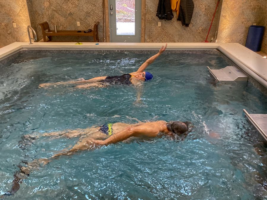 picture of Terry and Sara swimming with the Endless Pools swim currents in their pool house