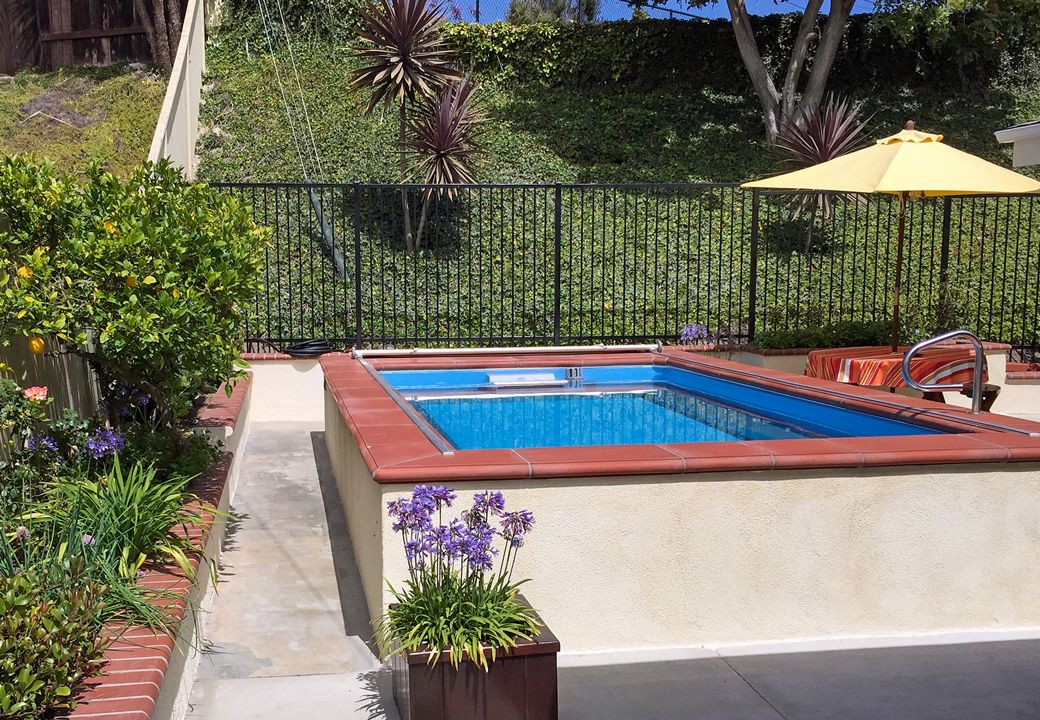 picture of Endless Pools partially in-ground pool in sloped backyard